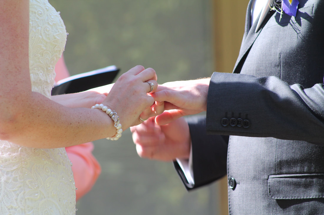 Groom putting ring on bride at a Northern Rivers wedding ceremony